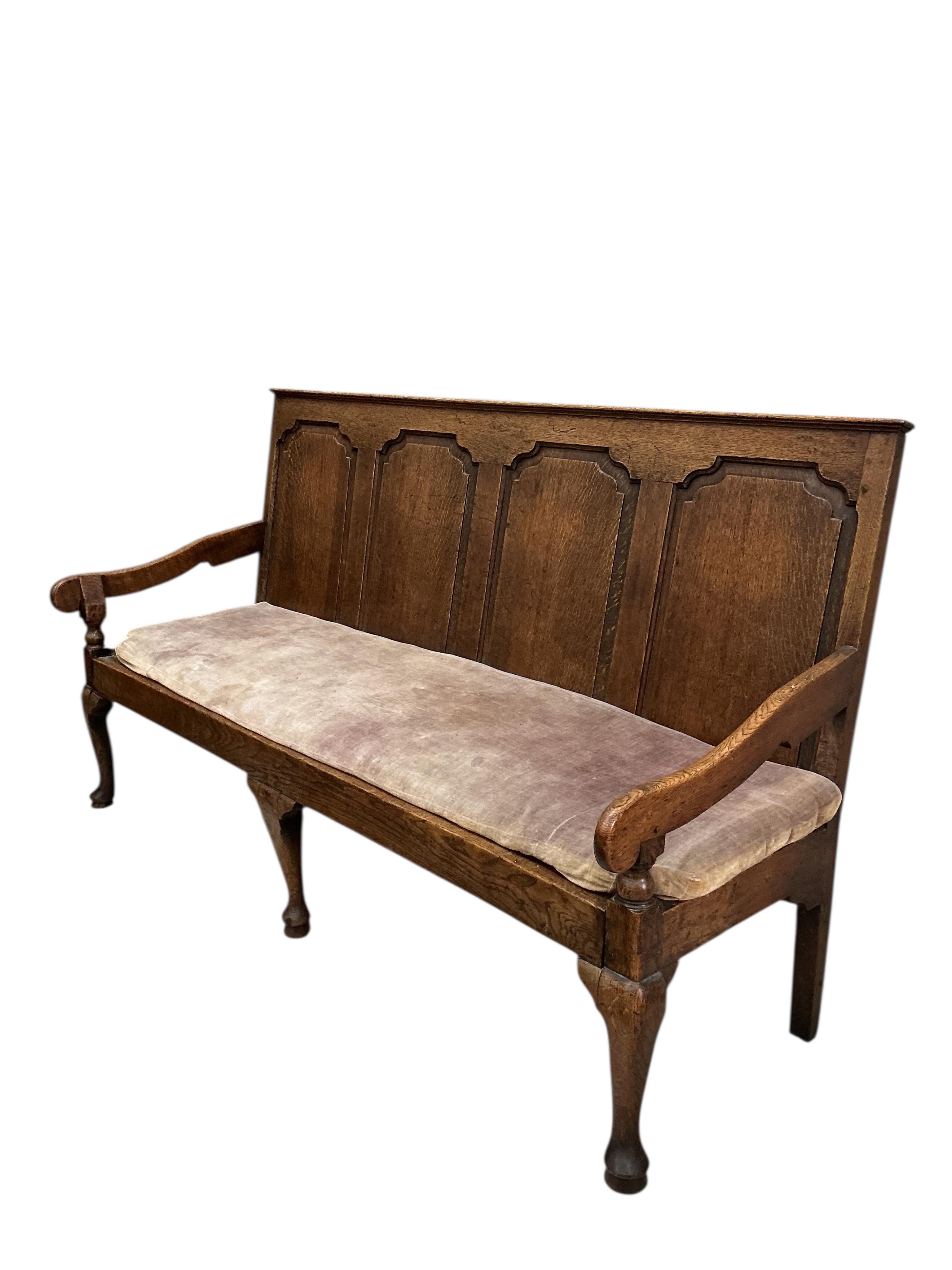 A George III oak settle, width 184cm, depth 64cm, height 107cm